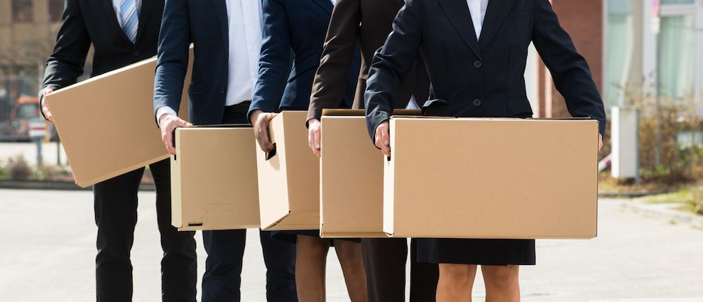 Business people carrying moving boxes