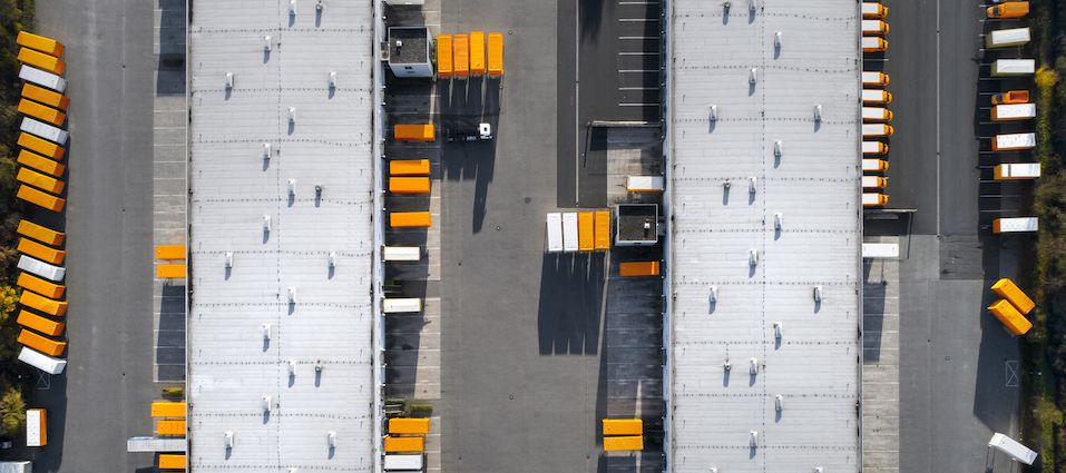 Storage and warehouse facility with moving containers parked in front with top view