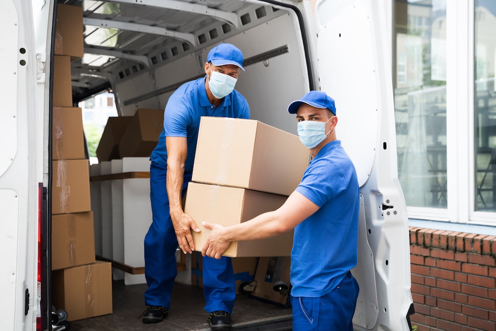 Delivery Men Unloading Cardboard Boxes