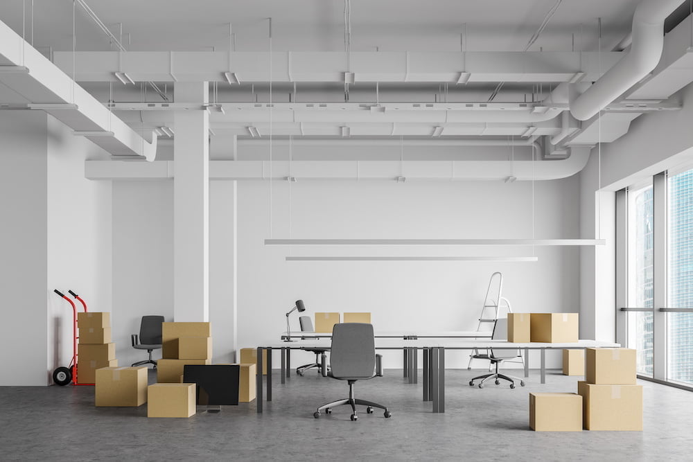 Cardboard boxes with equipment in spacious white open space office interior. Concept of moving and delivery. 3d rendering