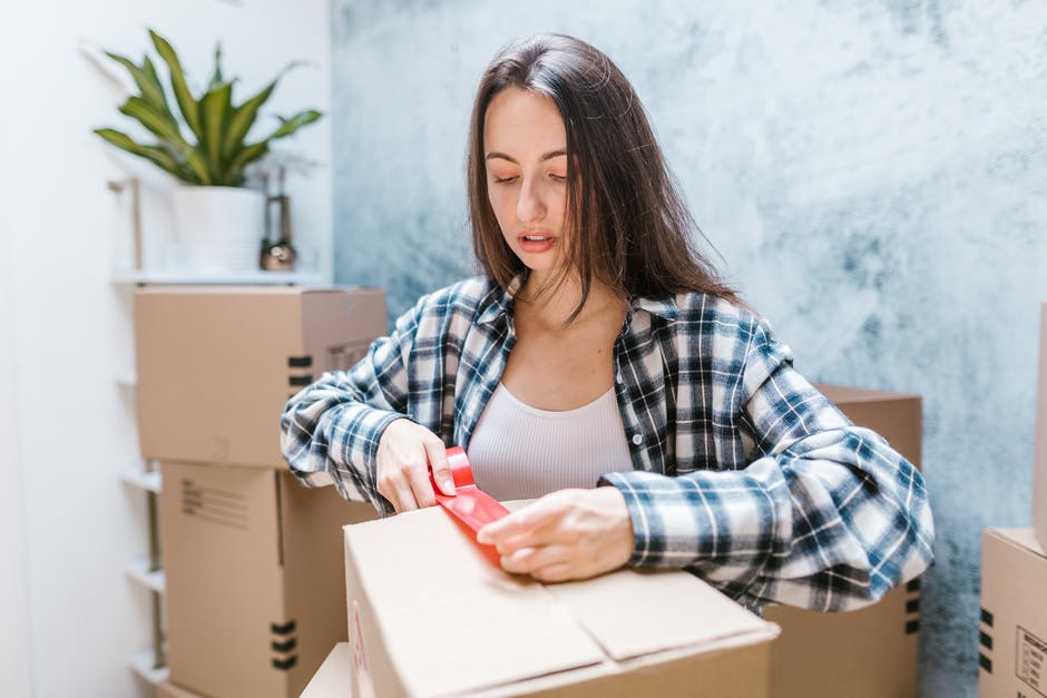 Woman packing moving box