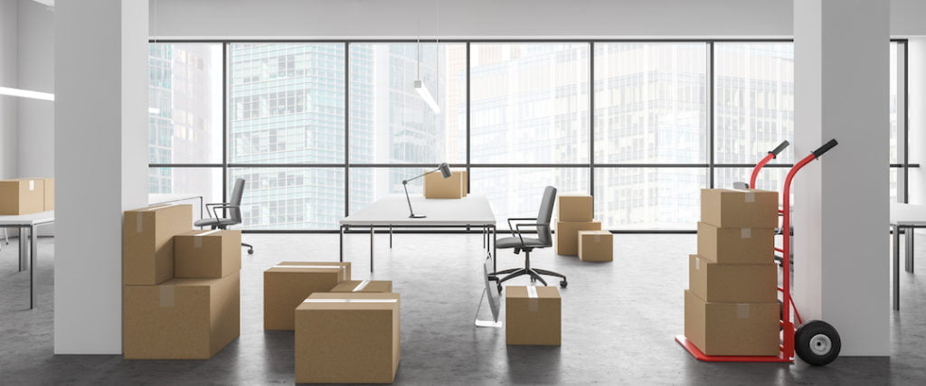 Open office with moving boxes