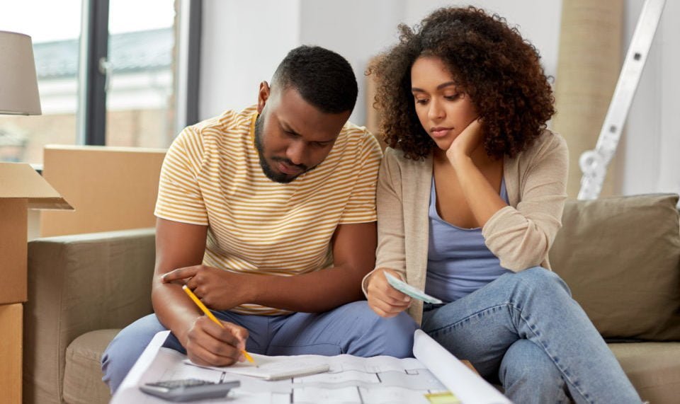 A couple looking over a plan and budget for their new home