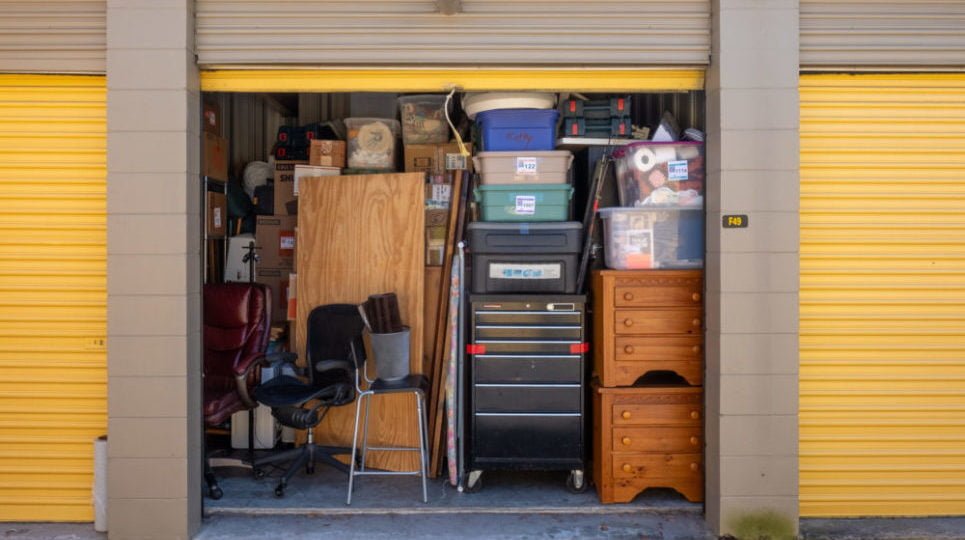 An open storage unit revealed a fully packed space with boxes and furniture