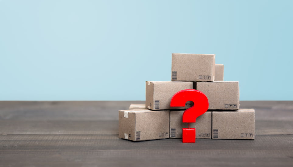 stack of moving boxes with question mark in front