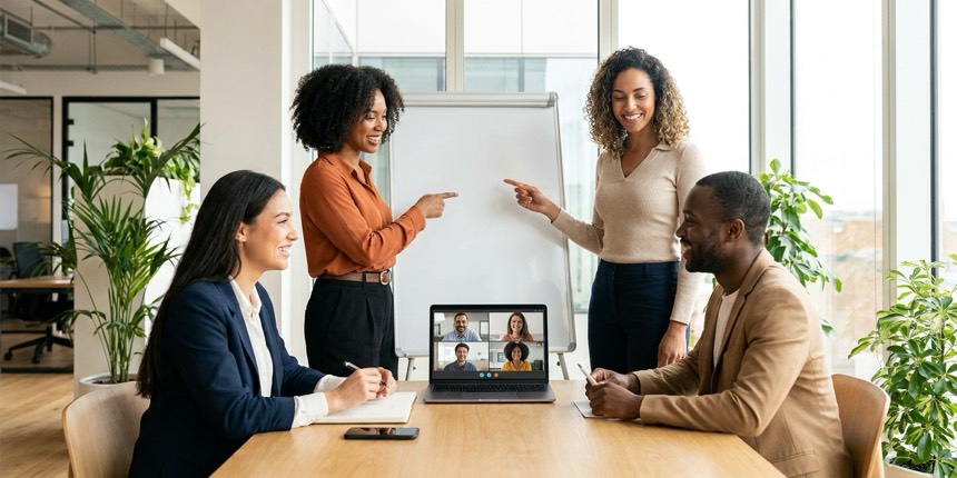 A hybrid workplace team collaborating in person and with remote colleagues on video