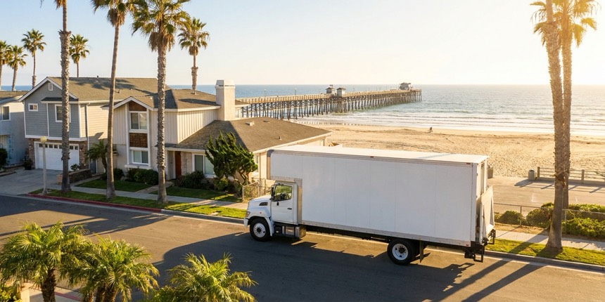 A moving truck outside a home in Oceanside, California near the pier and beach